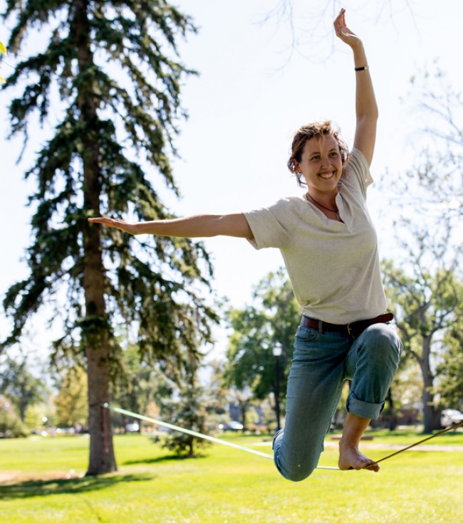 Person balancing on a rope in the park 