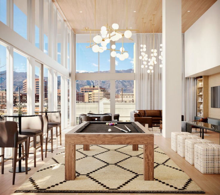Large well lit lounge and game room with billiards table 